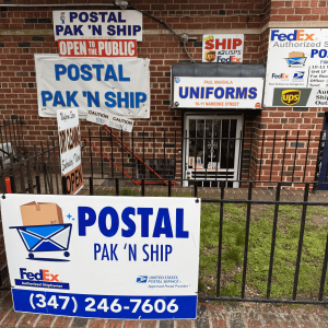 The outside of Postal Pak N Ship with signs for their business.
