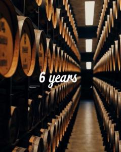 Aging warehouse showing stacks of wooden barrels used for the 6-year aging process of Mountaineer Brothers Blue Lot Bourbon.