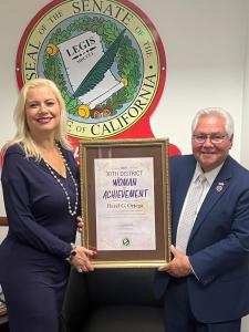 Hazel Ortega receiving the 2025 Woman of Achievement Award from Senator Bob Archuleta, a recognition for her impactful service and dedication to uplifting communities through education, empowerment, and action.