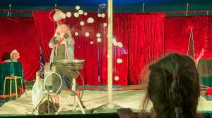Soap bubble artist Olga blows bubbles with smoke through a bubble wand