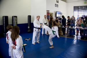 A young student breaks a board during the United Dojos fire relief open house last March. Just three weeks after the fires, the dojo reopened temporarily in Santa Monica—and within two months, hosted a major event to help the Palisades heal. Photo credit: Diamond Media.