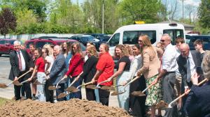 Representatives from Scioto Valley Local Schools, Valley View Health Centers, and other partners shovel dirt from a pile during a groundbreaking ceremony in Piketon, OH