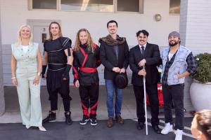 Hazel Ortega with Brunson K. Delves and his dynamic stunt team, the creative force behind the live-action performance that brought courage, movement, and empowerment to life for the Hero Initiativ