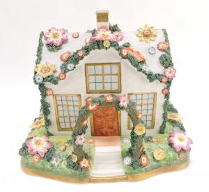 Large, circa 1850 Staffordshire porcelaneous pastille burner featuring a country cottage embellished with flowers, 10 inches tall by 12 inches wide. Estimate: $800-$1,200