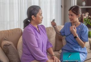 Basic Healthcare Aide assessing patient