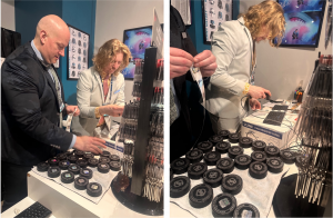 Two men stand in front of a table with game-used pucks working to apply NovaVision hologram stickers and scan them into a computer system