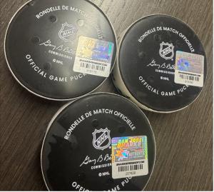 Three pucks with hologram labels on a tabletop