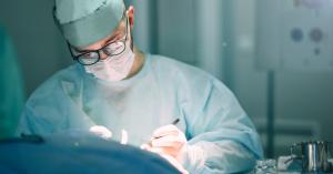 surgeon operating on patient