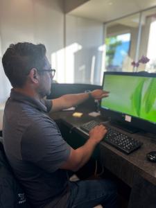 Desk worker learning about proper ergonomics at The Joint Chiropractic in Pasadena, CA