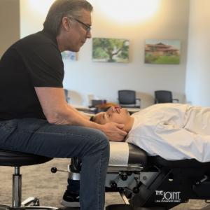 Chiropractor Gerald Edwards performing a cervical adjustment.