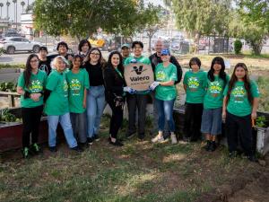 Valero leadership and volunteers pose with Sharefest staff at Banning High School in Wilmington, standing together in front of a newly beautified parkette during an Earth Day service event.