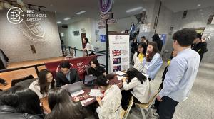 EBC staff members assisting students at event registration table during IUU Career Day - EBC