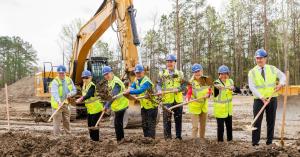 Syncon LLC employees with shovels for ground breaking