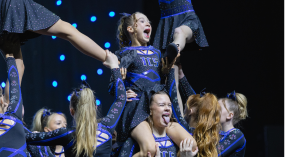 Happy cheerleaders build pyramid at Legacy Cheer and Dance, sponsored by The Perfume Shop