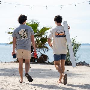 Two boys walking towards the beach