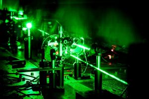 A green laser passes through a series of different equipment.