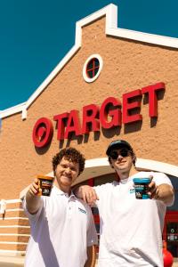 Protein Pints Founders Mike & Paul holds pints of their ice cream outside of a Target store with the Target logo clearly shown