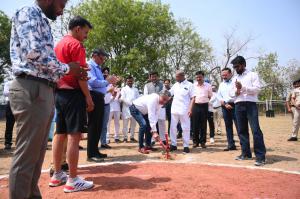 A group of men, including Mr. Kanwal Sra, CEO of Diamond Dreams Academy stands around a red circle at the groundbreaking for India's first professional baseball park.