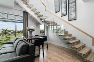 Modern 1-bedroom, 2-bath vacation rental at SoCe Flats 210 in Downtown Naples with floor-to-ceiling windows, luxury finishes, and walkable beach access.