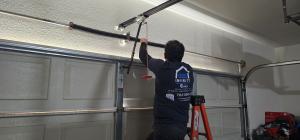 Infinity Garage Door Repair technician inspecting a garage door for safety and repairs in Las Vegas.