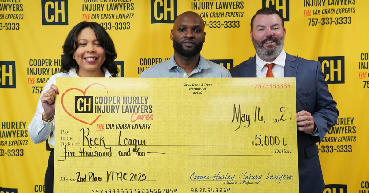 Photo of a large donation check held up by two men and one woman