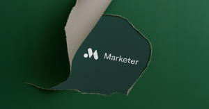 Torn piece of paper showing the new Marketer logo
