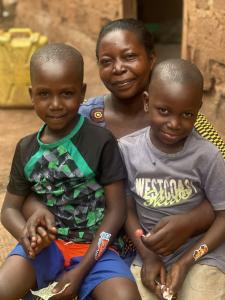 A foster mother in Uganda shares a moment of joy with the two boys she lovingly cares for through Love Without Boundaries’ family-based foster care program.