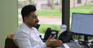 Attorney Ludwig seated at his office desk speaking with a client about their legal options at The Valley Law Group.