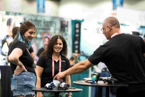 Two women shopping at the Scuba Show for the latest in marine equipment and technology