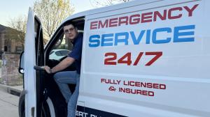 Denys Kavaler standing by emergency plumbing van, ready for urgent 24/7 service in North Dallas area