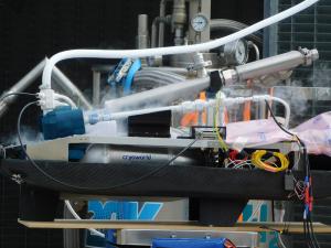 Close-up of AeroDelft’s liquid hydrogen aircraft powertrain with visible frost and vapor during cryogenic tank filling