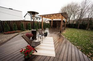 Deck setup with outdoor metal heater and wooden chairs, ideal for cool evening entertaining.
