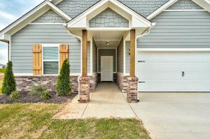 Exterior view of 5325 Little Foot Lane, a two-story Craftsman-style home with a gabled roof, 2-car garage, and wood shutter accents in Guthrie, OK.