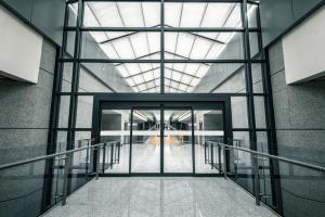 Modern office building with sleek automatic glass doors at the main entrance.