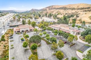 Aerial view of commercial buildings and parking lots adjacent to the future apartment development site at 29045 Agoura Road in Agoura Hills, CA, near freeway access and retail amenities.