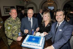 NATO Association of Canada's CEO Robert Baines, Board Member Lisa Shymko and BGen R.T. Strickland showing the celebratory cake at NATO's 75th anniversary celebrations in Canada