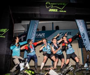 team is celebrating successful finish at X-Marathon adventure race