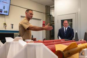 Secretary of the Navy John C. Phelan receives a briefing from Naval Postgraduate School student U.S. Marine Corps Maj. Dillon Pierce, a PhD candidate in Space Systems, about his missile research during a visit, May 29. (U.S. Navy photo by MC2 Janiel F. Adames)