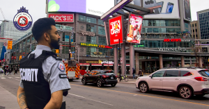 G Force Security officer monitors urban activity at a busy downtown intersection in Toronto.
