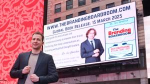 Dr. Ivo Ganchev stands in front of a Times Square billboard promoting his new book, The Branding Boardroom, which features the global release date of March 15, 2025, and highlights the book’s focus on branding insights from global thought leaders.