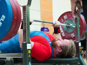 Photo of Adam Sivia lifting weights