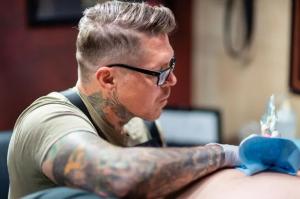 Tattoo artist Jason “Elvis” Martin creating a custom piece inside his private Nashville studio, known for high-integrity, one-on-one sessions.