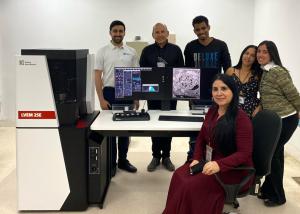 The team at UNDP and the applications engineer at Delong America stand around the LVEM 25E electron microscope