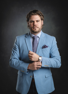 A picture of founder and chief brand officer for AVANTI wearing a suit and tie.