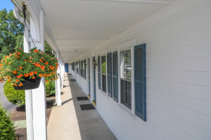 Outdoor entrance to suites lined with hanging flower pots
