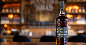 Bottle of Tennessee Hills Cask Strength Bourbon displayed on wood surface with branded label and gold medal recognition.
