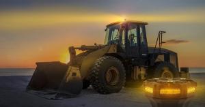 Picture depicts a MicroBright Beacon in use on a loader in the background, with a close up PNG of the beacon in the foreground.