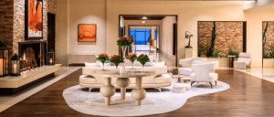 Elegant hotel lobby featuring a cozy seating area, modern decor, a welcoming fireplace, and stylish plants.