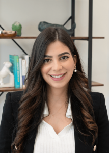 Dr. Julie Velazquez wearing a black jacket and white blouse