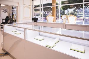 Glass jewelry case at Apollo Studio featuring exclusive BVLA 14k gold body piercing jewelry in a bright, elegant showroom.